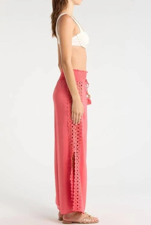 side profile of a woman wearing coral pants with lace details