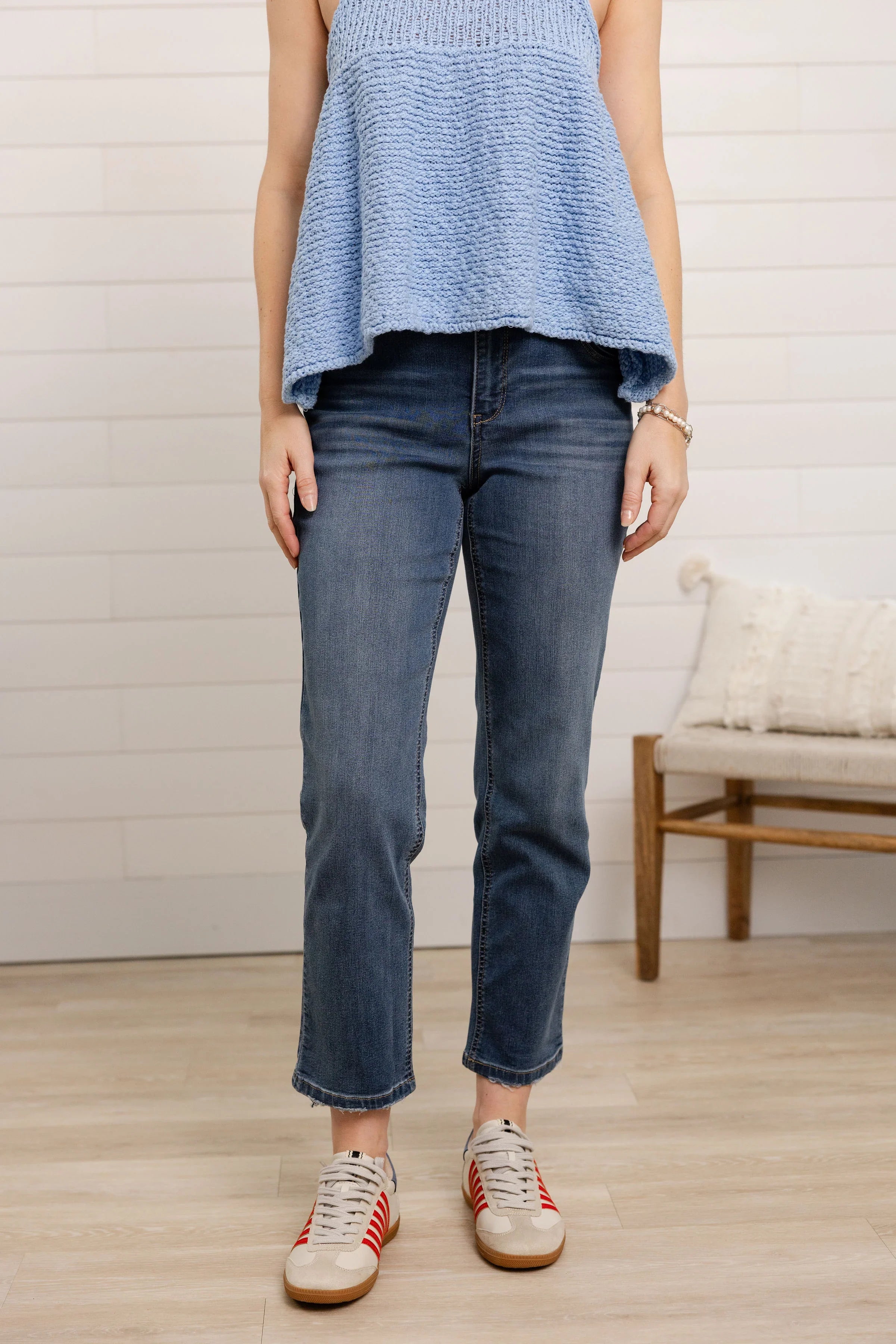 Person wearing high rise slim straight jeans