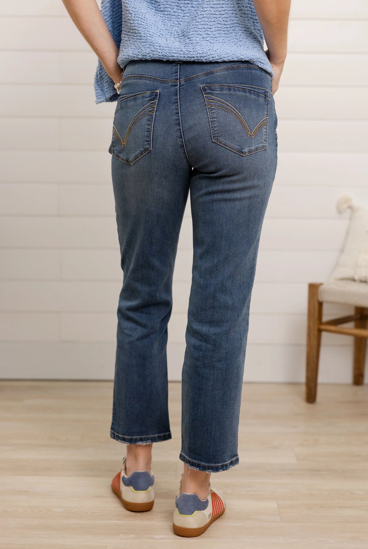 Back of person wearing high rise slim straight jeans