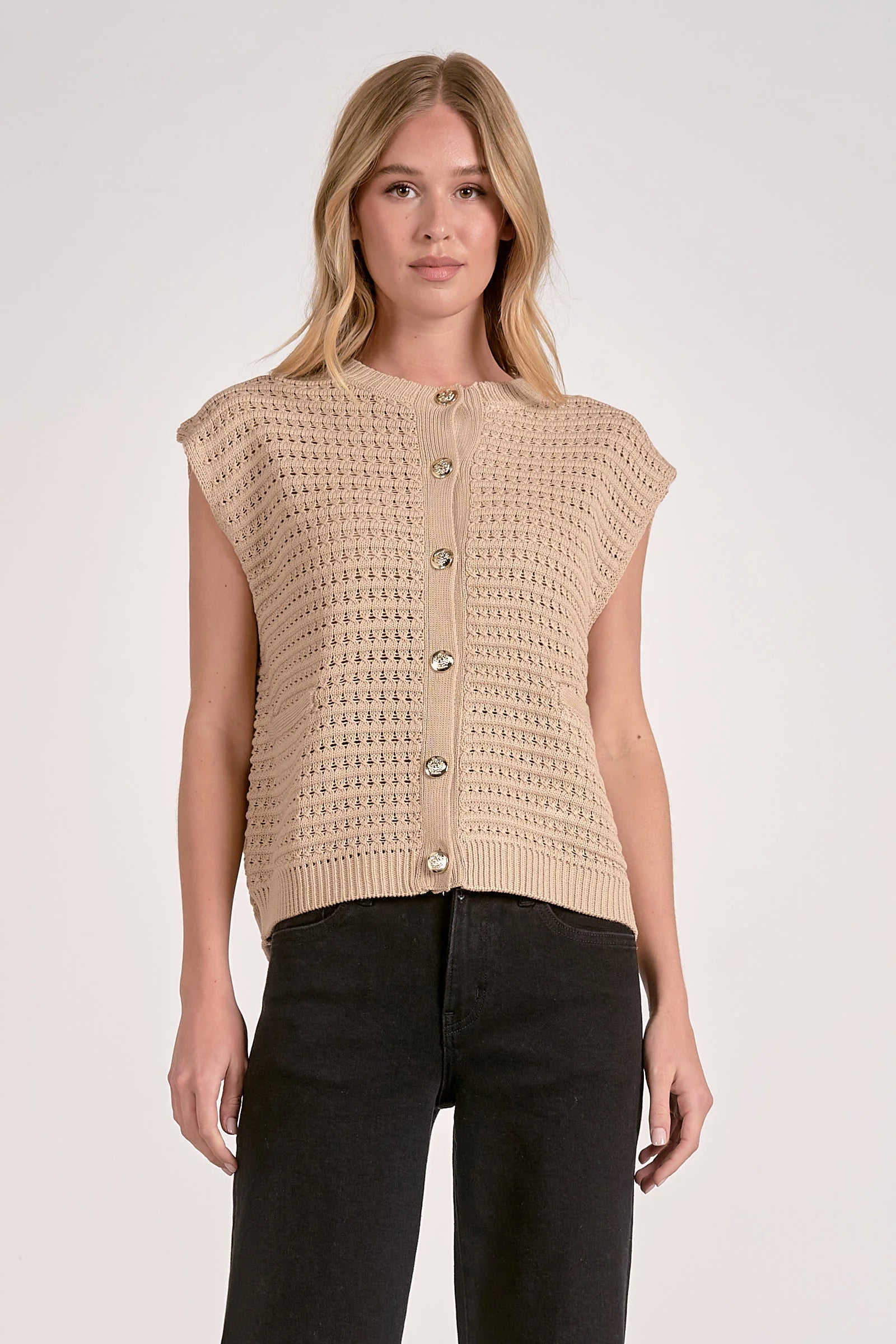 Woman wearing a beige knitted vest