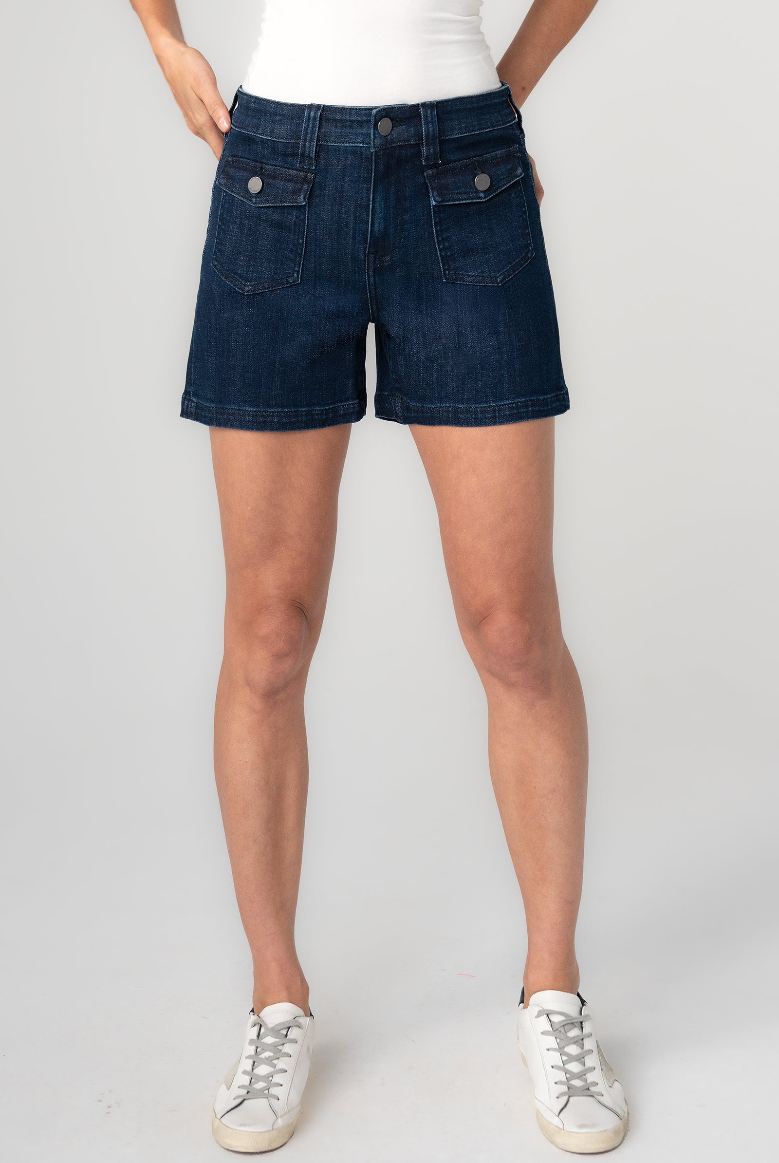 Person wearing dark blue denim shorts