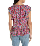 Woman wearing a colorful floral blouse