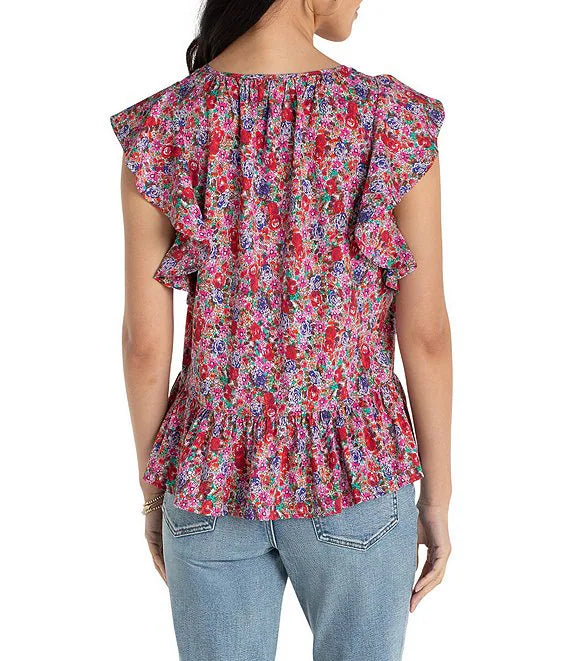 Woman wearing a colorful floral blouse