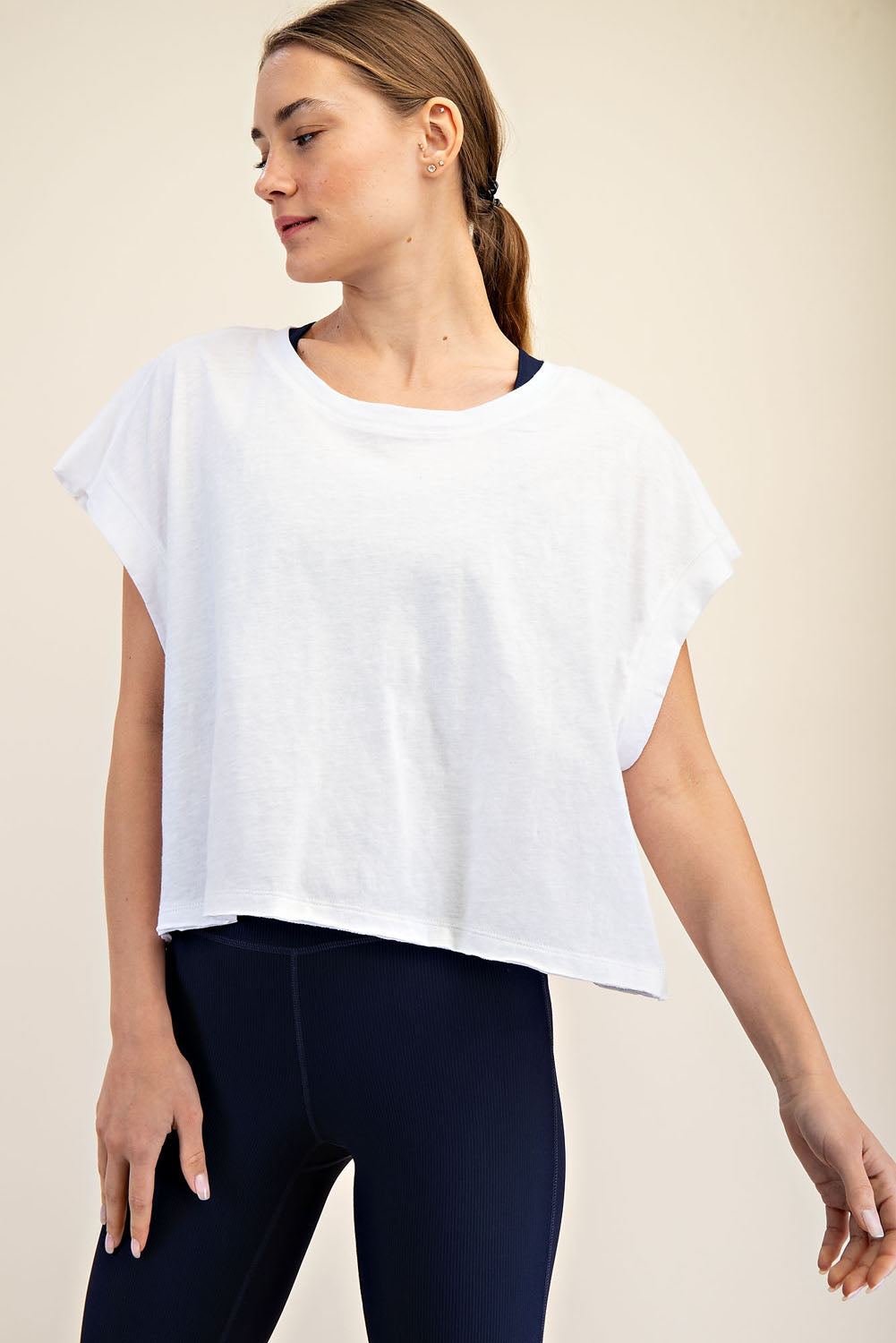 Woman wearing a white top with open back 