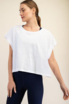 Woman wearing a white top with open back 