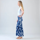 Side view of model wearing white shirt with blue print pants