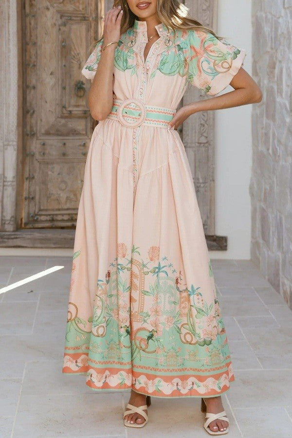 Woman wearing a peach floral dress with a belt 