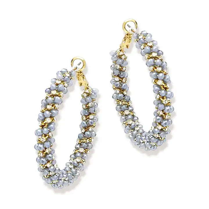 Blue and gold earrings on white background 