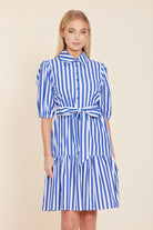 Woman wearing a blue and white striped dress 