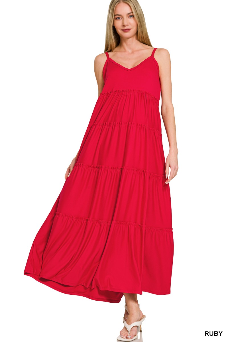 Woman wearing a red tiered dress on a white background