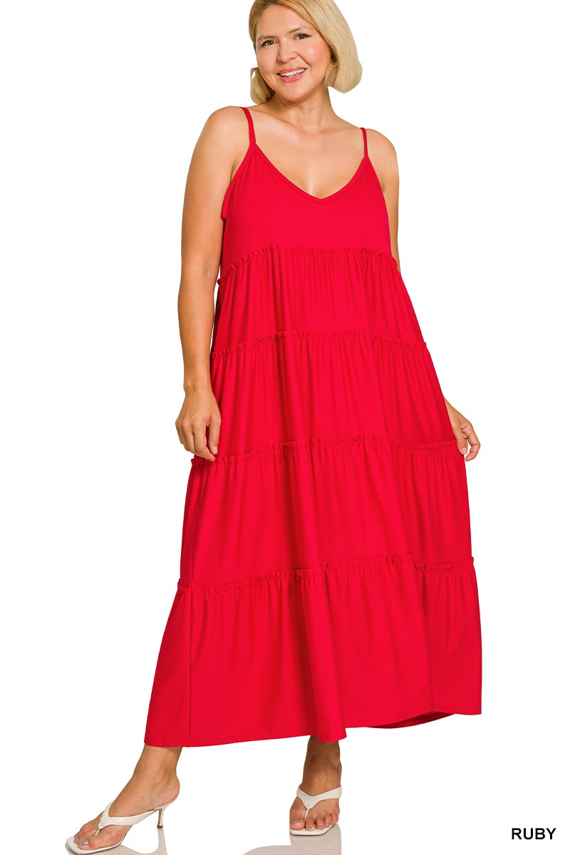 Woman wearing a red tiered dress on a white background