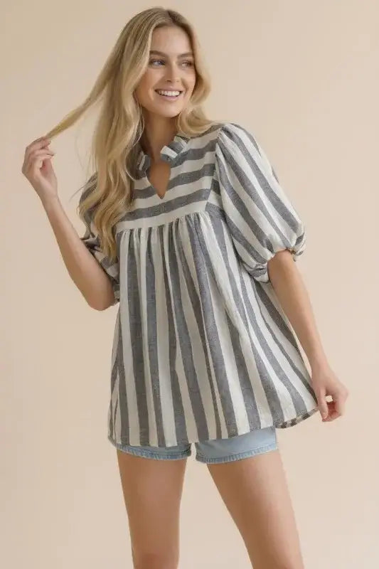 Woman wearing a striped shirt with bubble puff sleeves