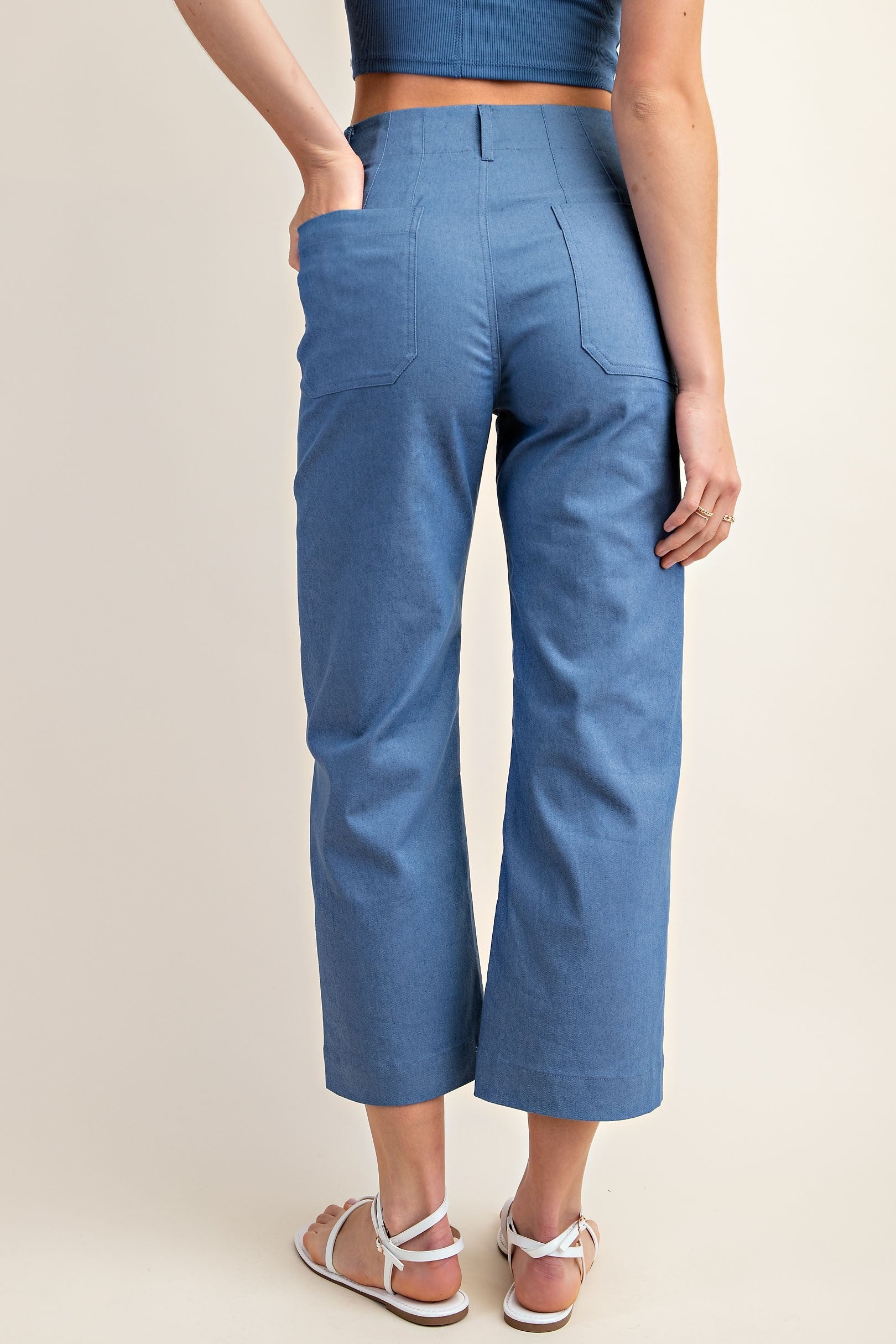 Back of woman wearing blue ankle cropped pants