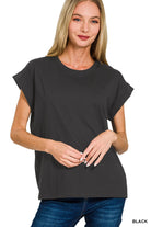 Woman wearing a black t-shirt with folded sleeves