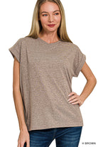 Woman wearing a brown t-shirt with folded sleeves