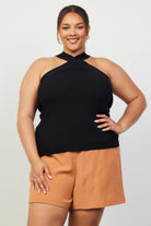Woman wearing a black crossed neck top 
