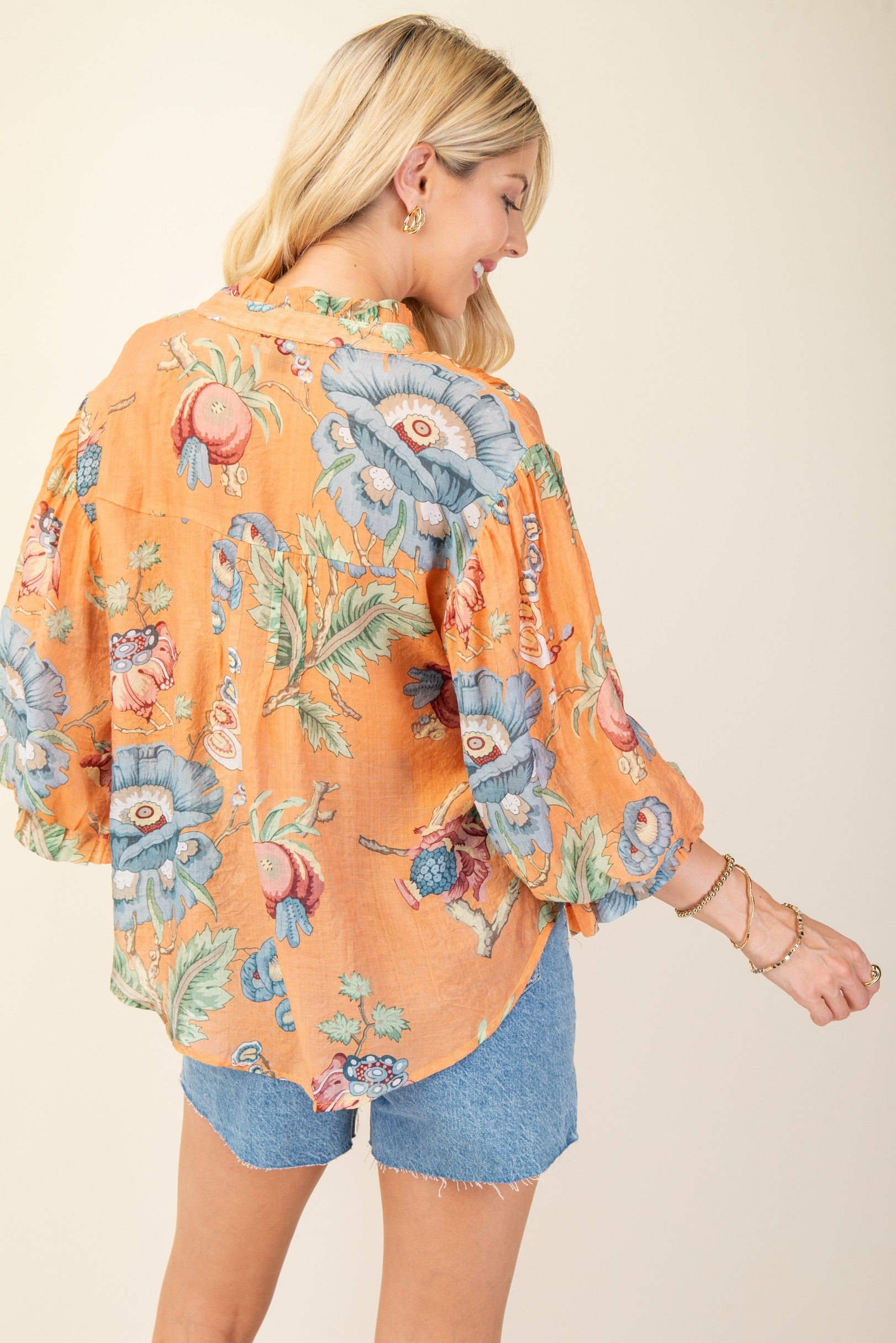 Back of woman wearing a colorful printed top