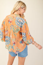 Back of woman wearing a colorful printed top