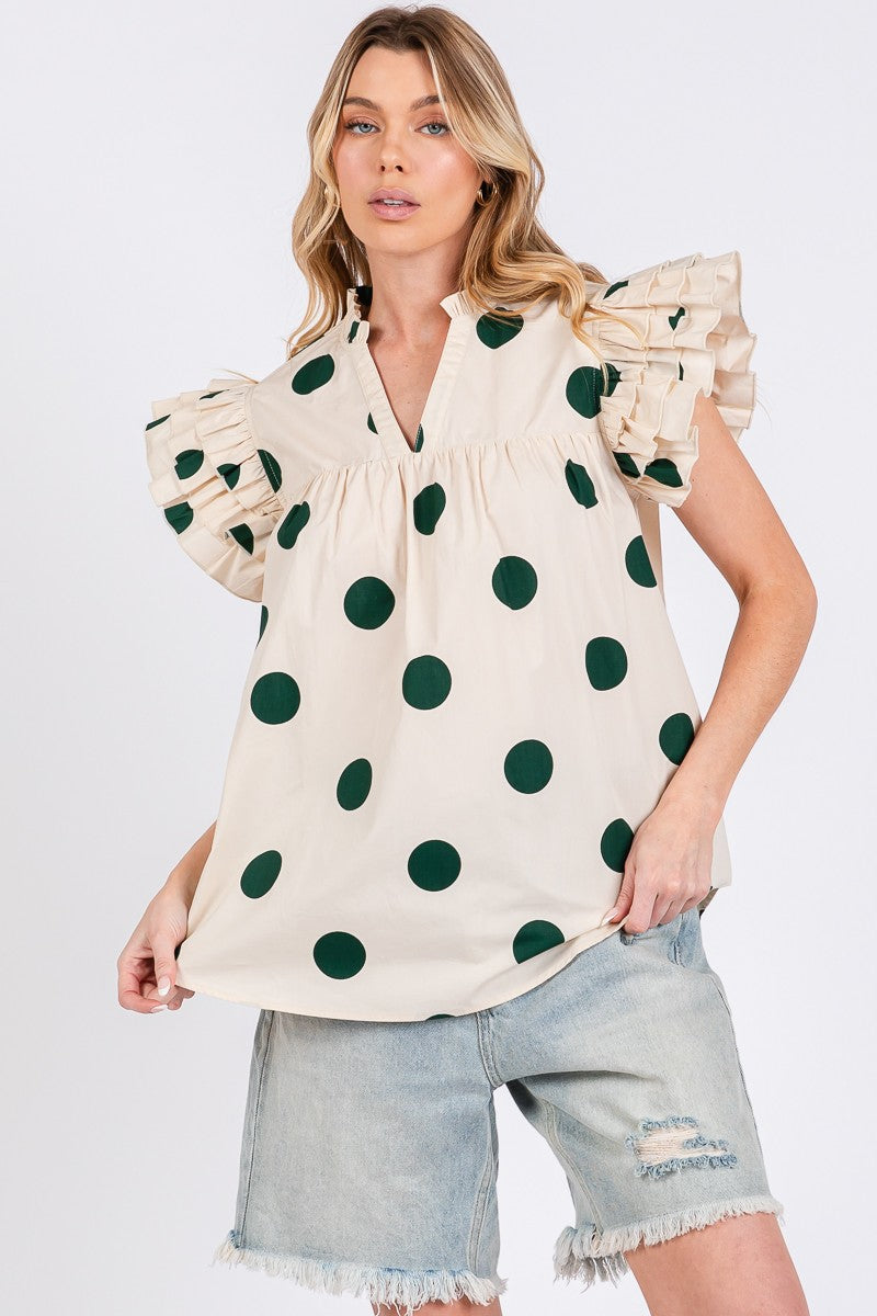 Woman wearing a polka dot blouse with ruffled sleeves