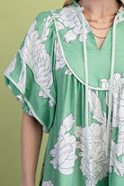 Green babydoll dress with white floral pattern 