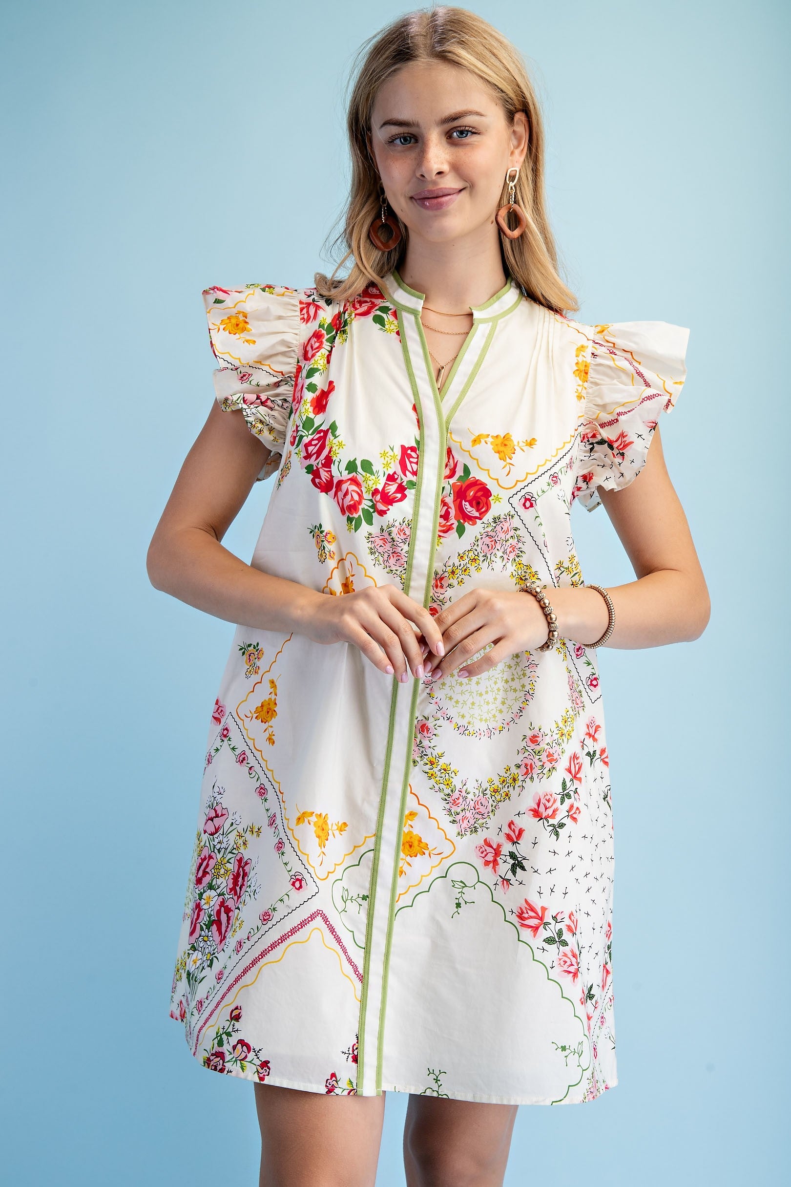 Woman wearing a floral dress with a zipper on a light blue background