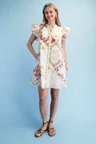 Woman wearing a floral dress against a light blue background