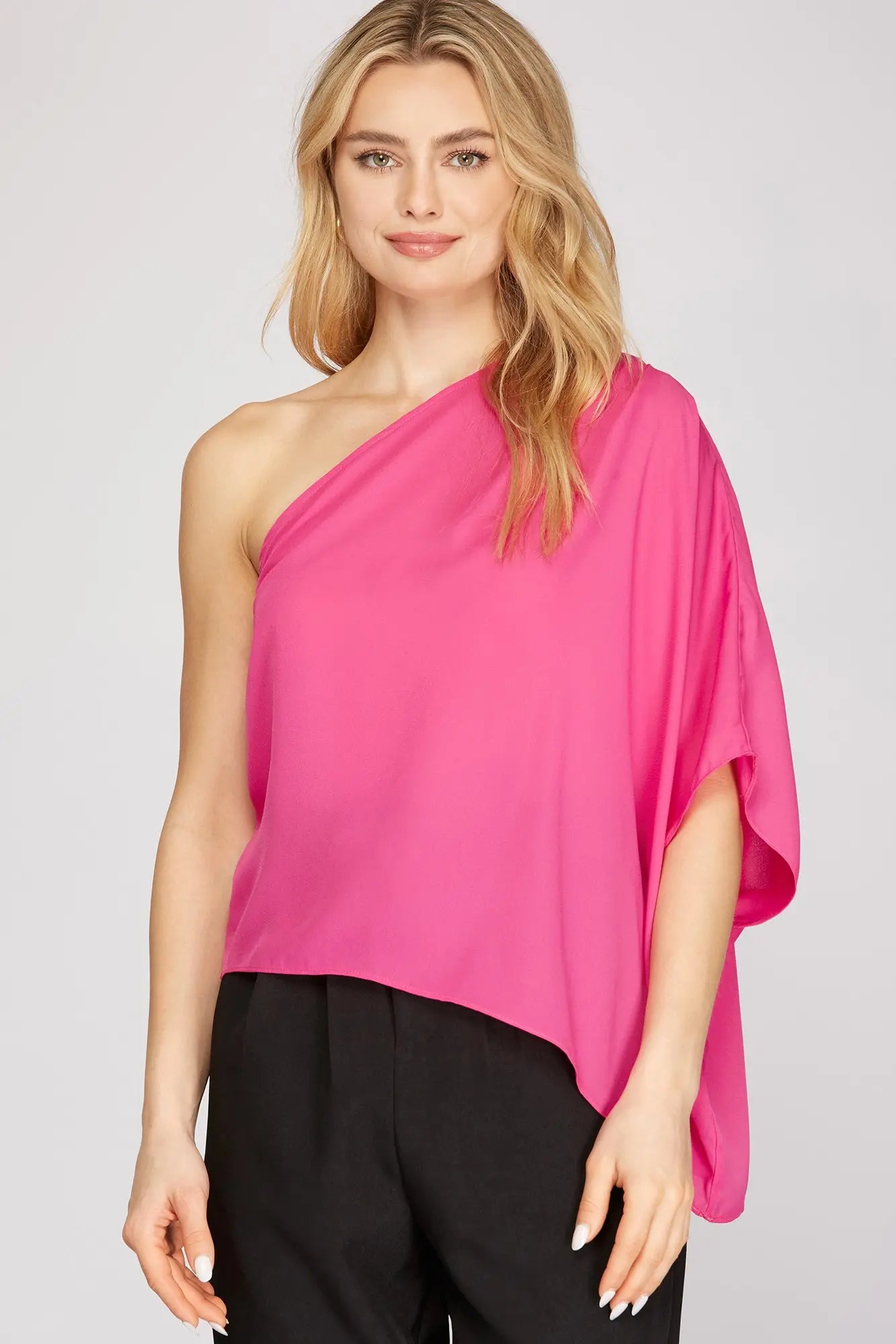 Woman wearing a bright pink one-shoulder top