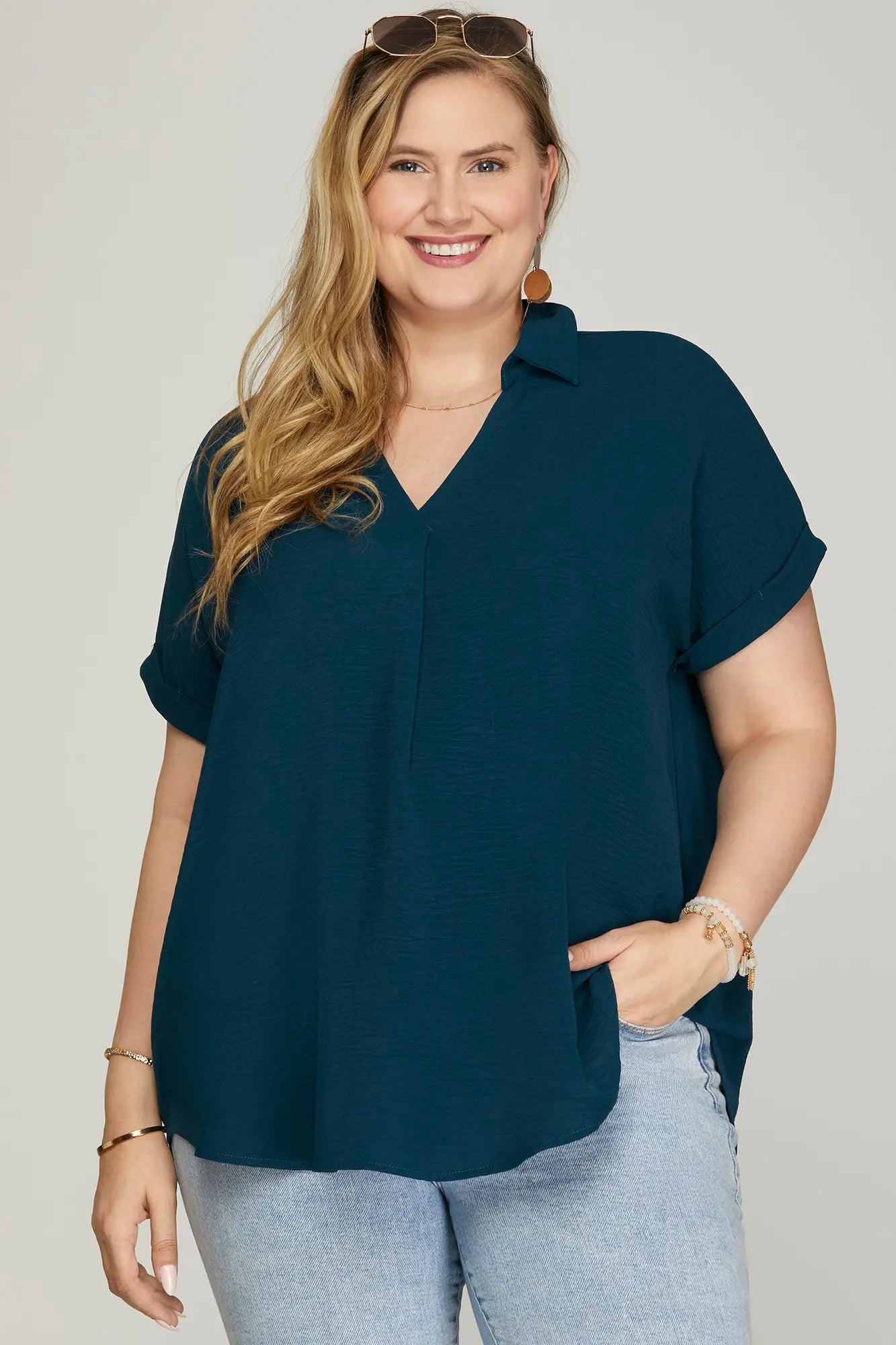 Woman wearing a blue drop shoulder collared top
