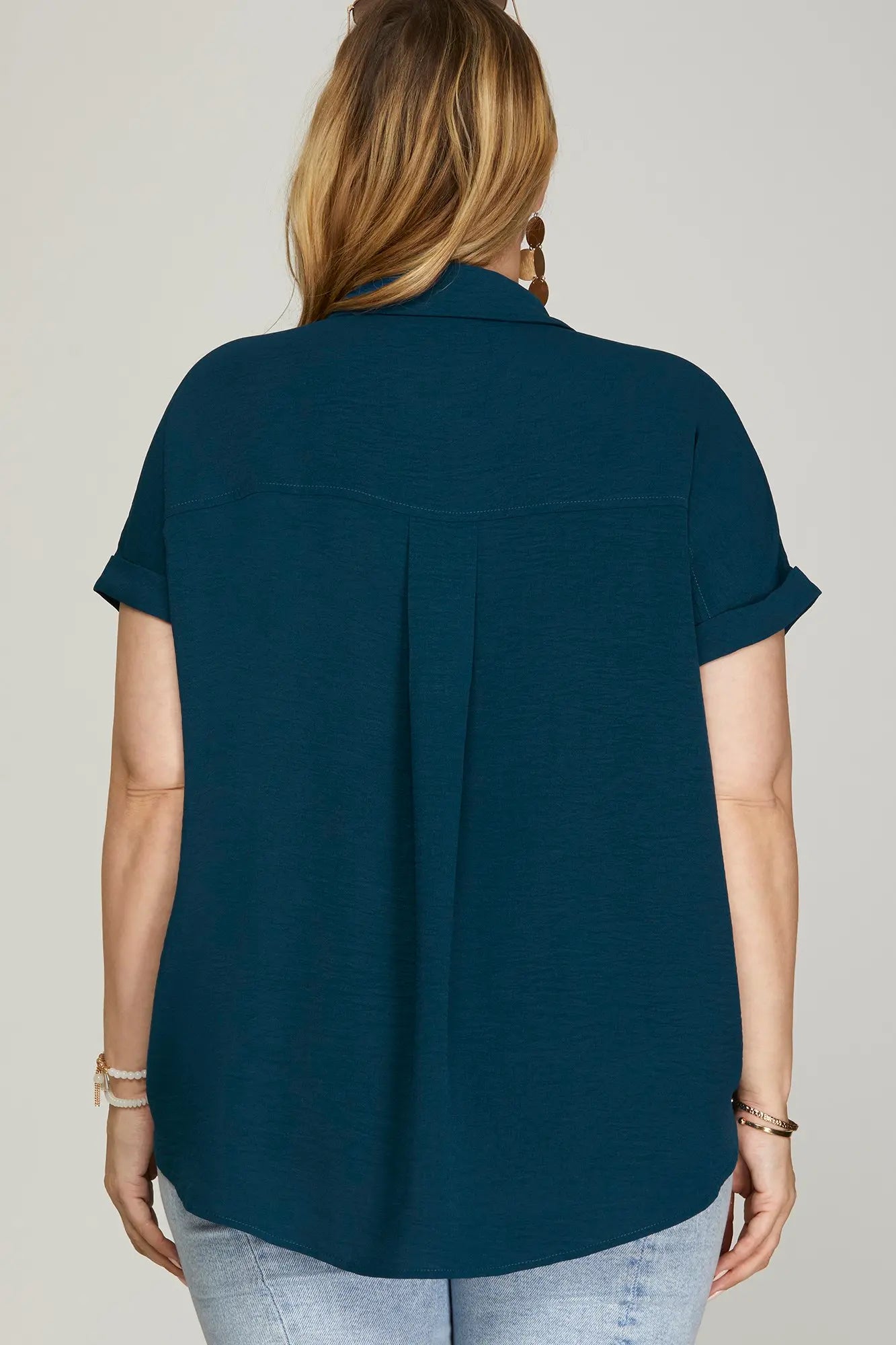 Back of woman wearing a blue drop shoulder collared top