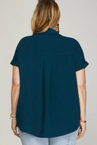Back of woman wearing a blue drop shoulder collared top