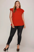 Woman wearing a red top with ruffle sleeve