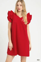 Woman wearing a red dress with ruffled sleeves 