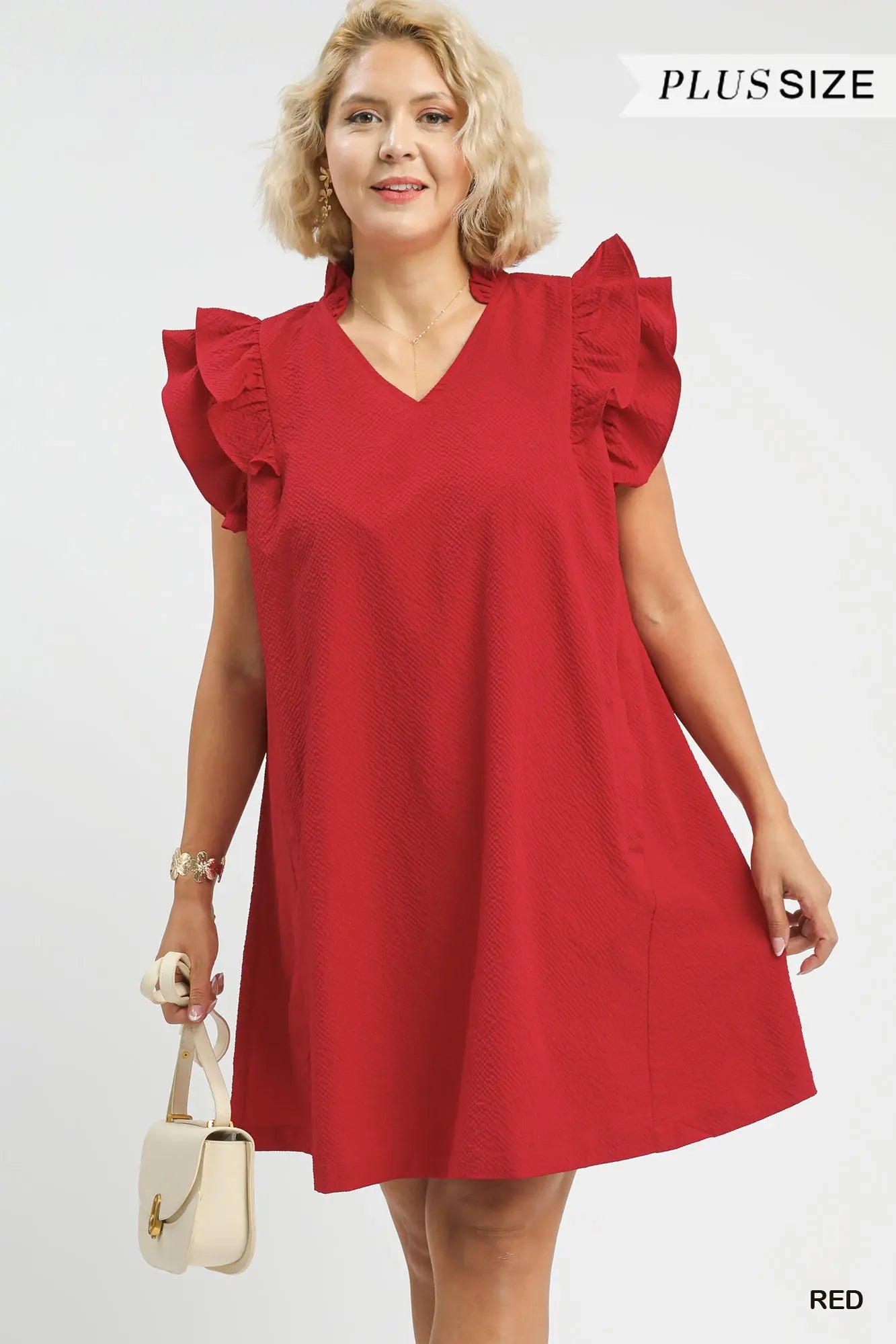 Woman wearing a red dress with ruffled sleeves 