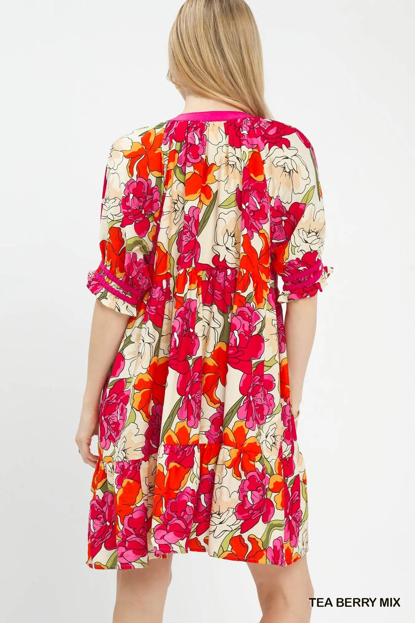 Back of woman wearing a floral tiered    babydoll dress 