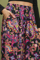 Colorful paisley patterned pants with a black background