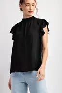 Woman wearing a black mock neck blouse