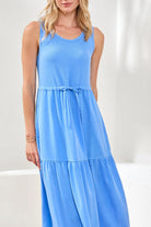 Woman wearing a blue sleeveless dress