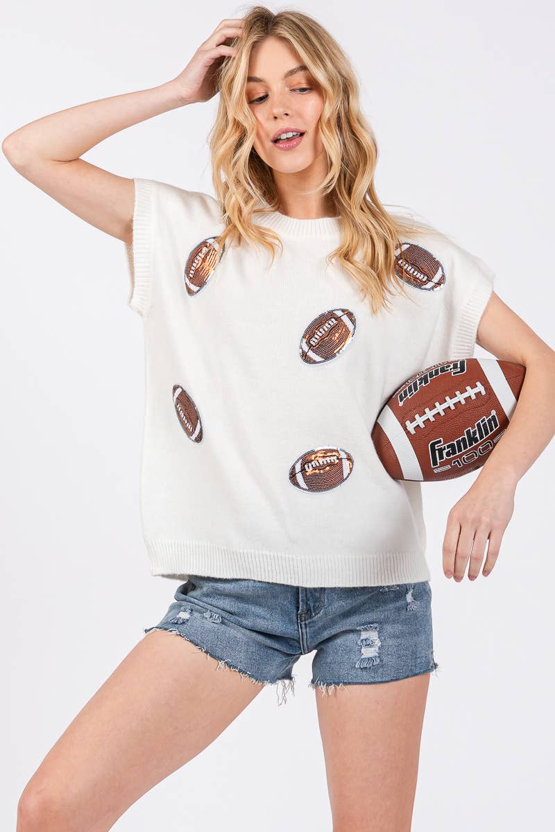 Woman wearing a white t-shirt with football graphics and denim shorts on a white background