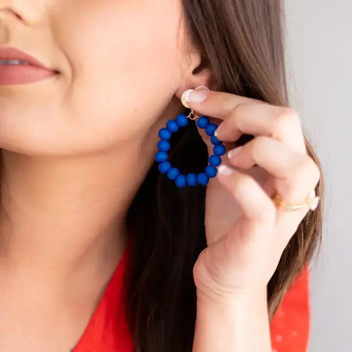 Model wearing royal blue earrings 