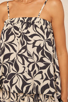 Black and white floral patterned top on a beige background