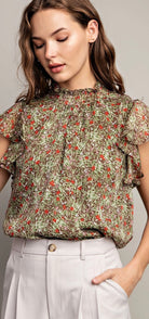 Front view of model wearing olive and floral tank with cream button