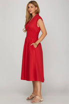 Woman wearing a red dress side view 