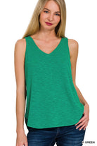 Woman wearing a green sleeveless top 
