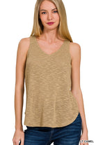 Woman wearing a light camel sleeveless top