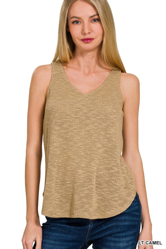 Woman wearing a light camel sleeveless top