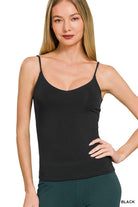 Woman wearing a black camisole against a white background
