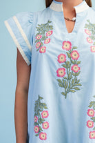 Light blue dress with floral embroidery on a plain background