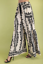 Black and white patterned pants on a green background
