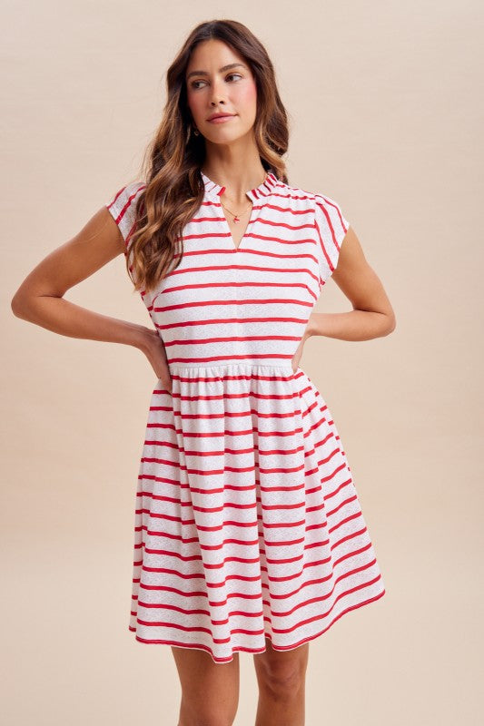 Woman wearing a red and white striped dress against a beige background