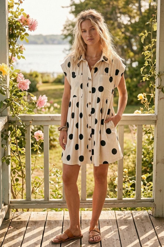 Model wearing cream dress with black polka dots 